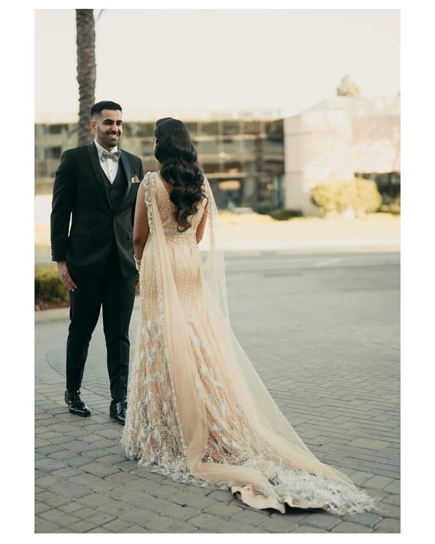 Mermaid trail gown with feathers and shoulder capes Ricco India