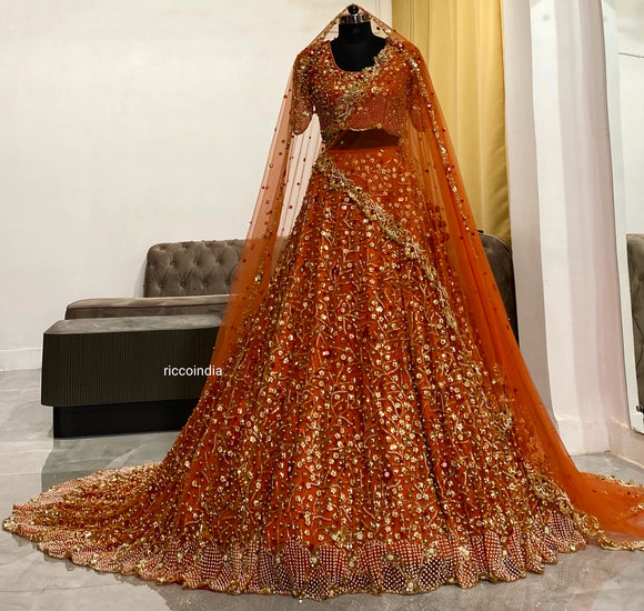 Orange bridal Lehenga with train and two veils Orange bridal Lehenga with train and two veils