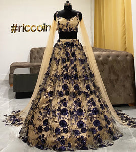 Gold lehenga with blue sequins work and shoulder capes