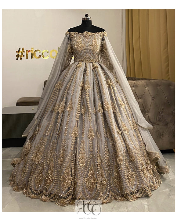 Grey pleated gown with gold beading and removable shoulder capes