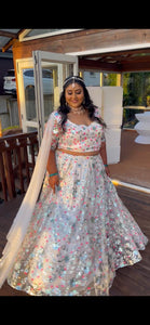 Ivory lehenga with teal and hot pink sequins work