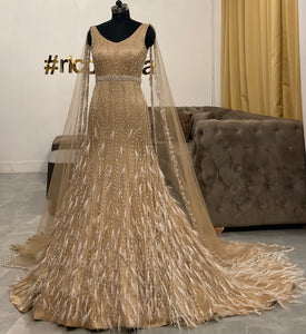 Champagne gold mermaid gown with feathers Ricco India Champagne gold mermaid gown with feathers Ricco India