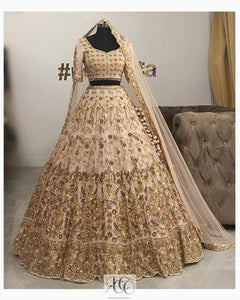 Rose gold bridal lehenga with red and green hints