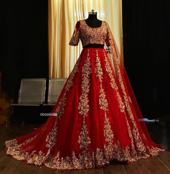 Red dori work lehenga with train.